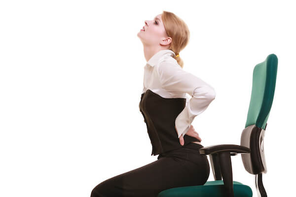 Business. Young businesswoman with backache. Woman with back pain isolated on white. Long working hours and health.