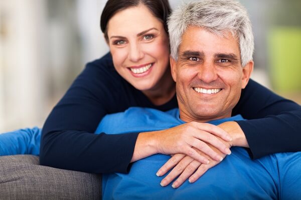 happy loving middle aged couple relaxing at home
