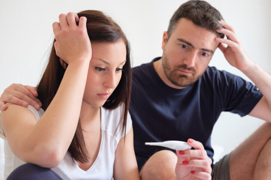 infertility evaluation Sad lovers couple after a pregnancy test result