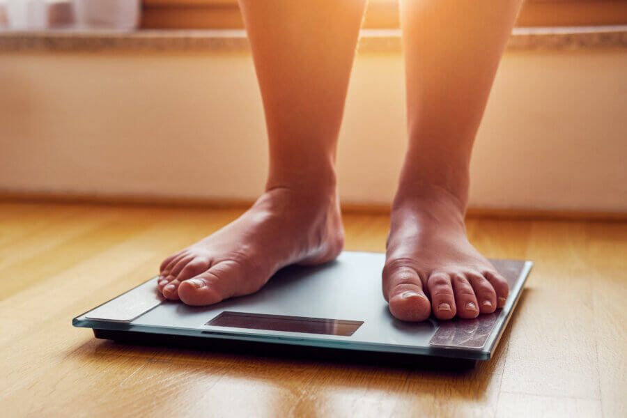 weight  Female bare feet on weight scale
