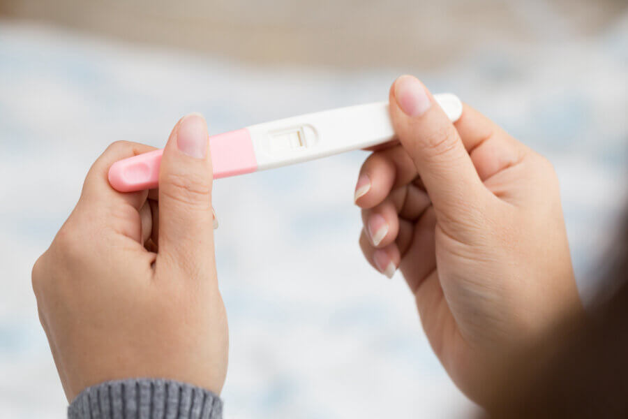 fertility testing Woman hand holding pregnancy test and result is not pregnant